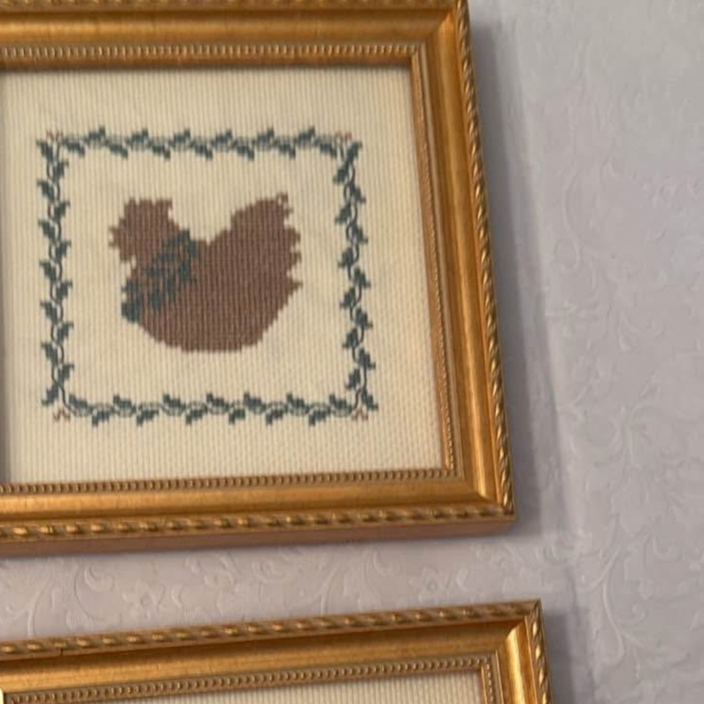 These are two framed pieces of cross-stitch embroidery… pig & hen